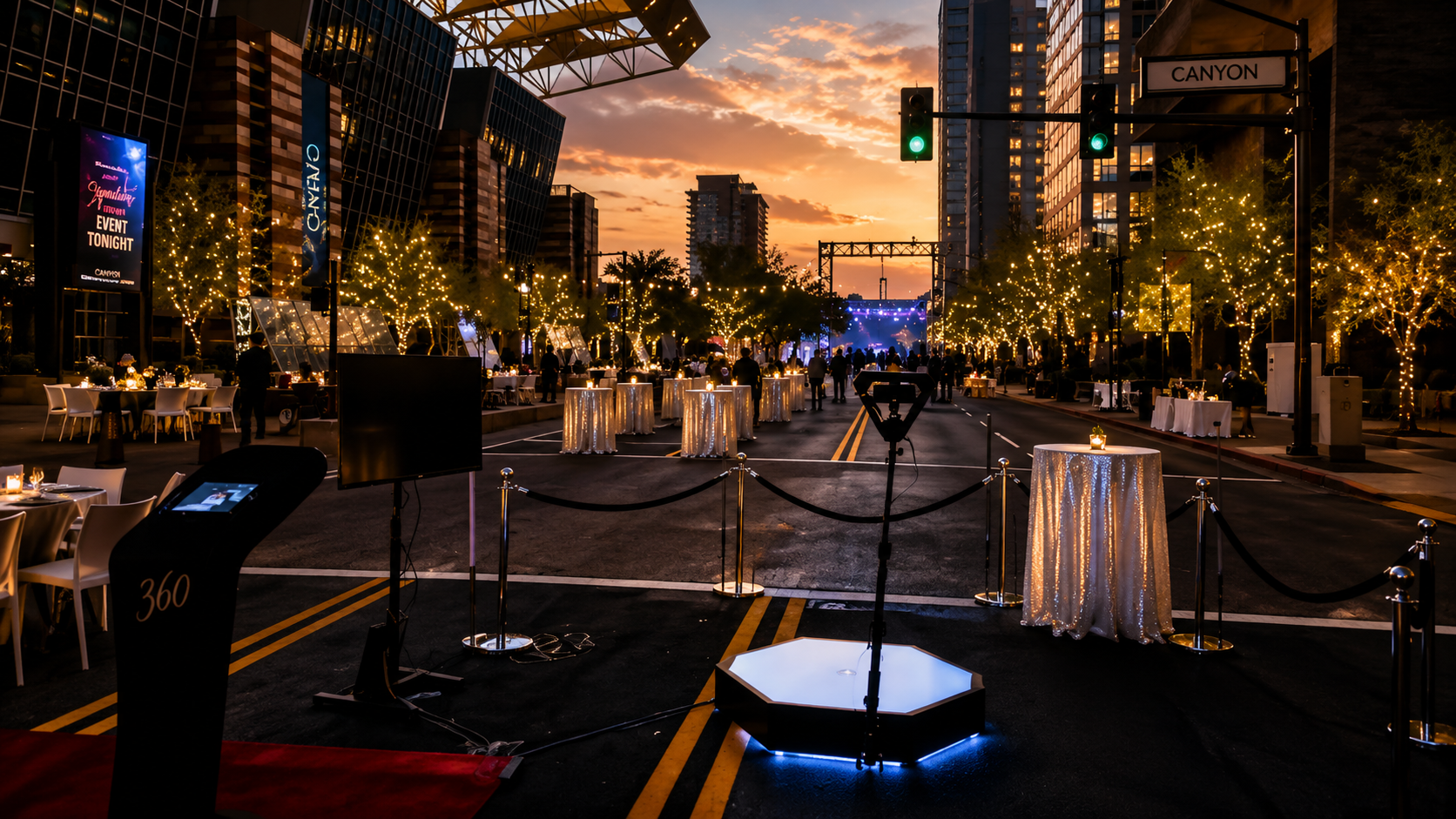 360 video booth on a downtown street at sunset with lit trees and cocktail tables